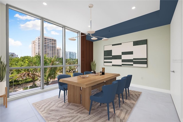 tiled dining area featuring expansive windows and a healthy amount of sunlight