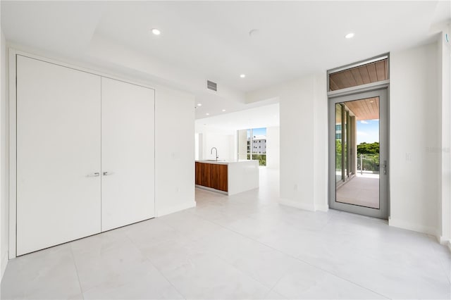 interior space featuring sink, access to exterior, and a closet