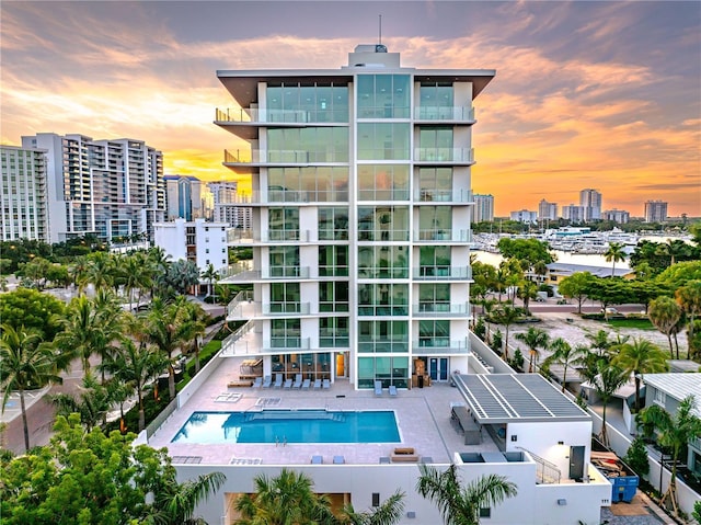 outdoor building at dusk featuring a community pool