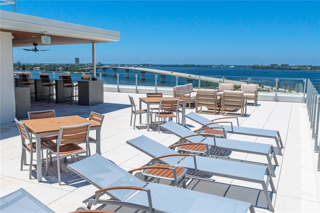 view of patio with a water view, ceiling fan, and an outdoor hangout area