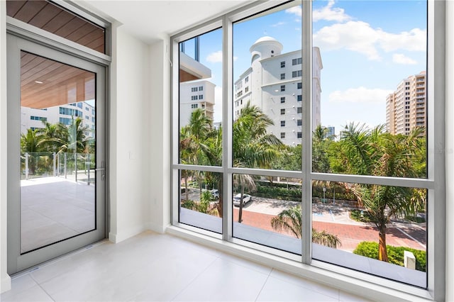 doorway with light tile patterned flooring and floor to ceiling windows