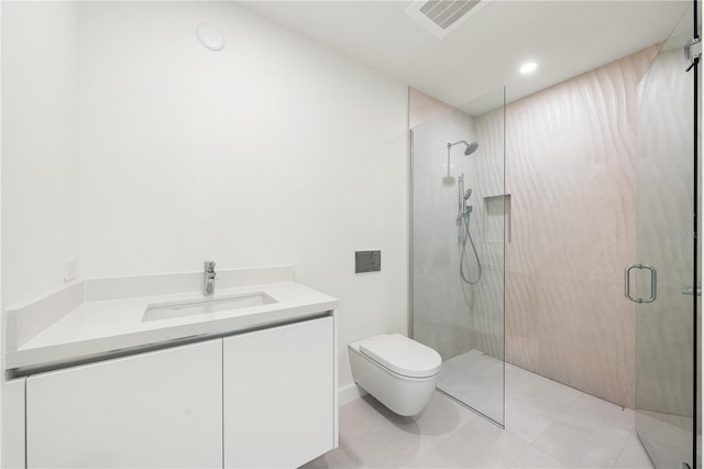 bathroom featuring vanity, tile patterned flooring, a shower with shower door, and toilet