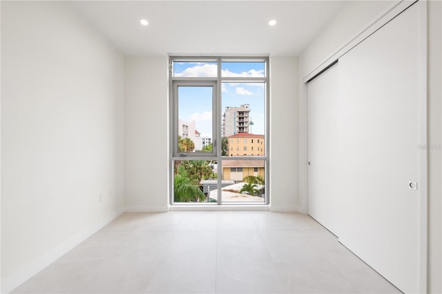 spare room with a wall of windows