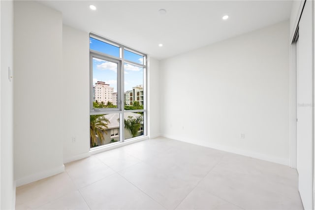 empty room featuring a wall of windows