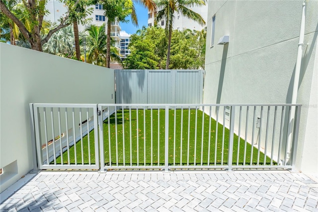 view of gate with a yard