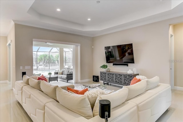 living room featuring ornamental molding and a raised ceiling