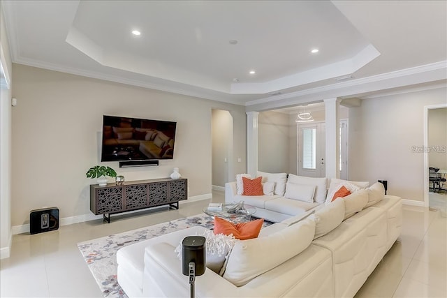 living room with a raised ceiling, ornamental molding, and light tile patterned floors