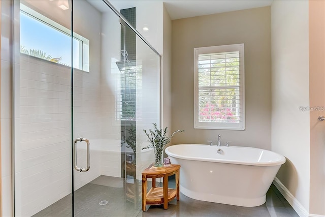 bathroom with separate shower and tub and tile patterned flooring