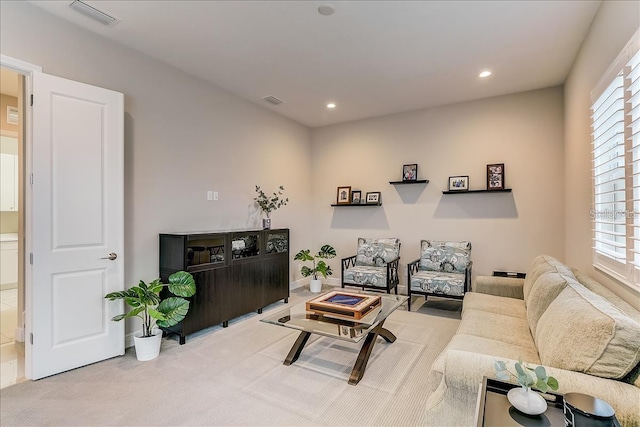 carpeted living room featuring plenty of natural light