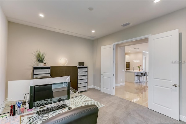 office area featuring light carpet