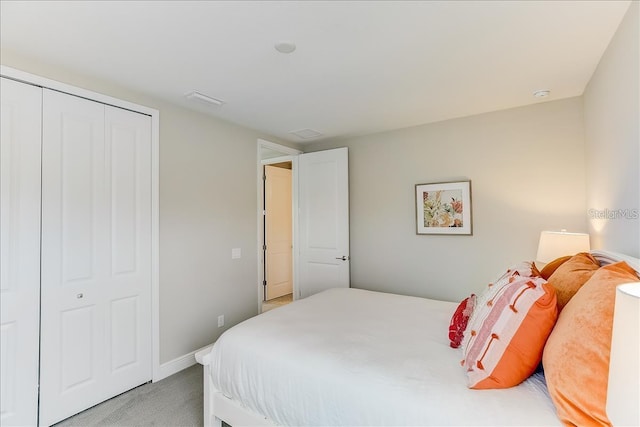 bedroom with a closet and light carpet