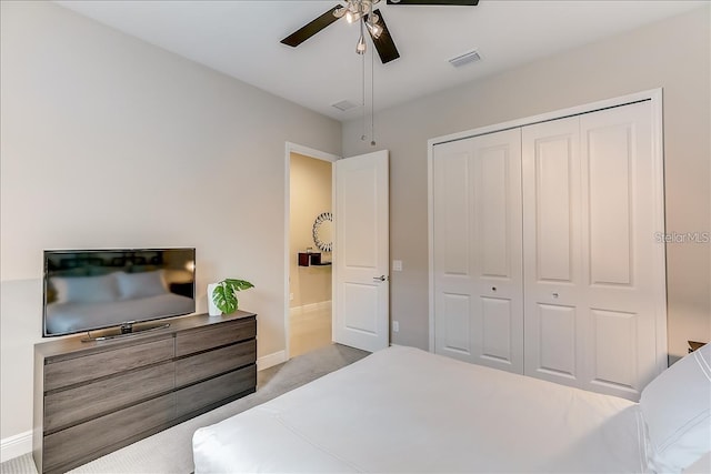 carpeted bedroom with ceiling fan and a closet