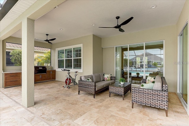 view of patio / terrace featuring exterior kitchen, an outdoor hangout area, and ceiling fan