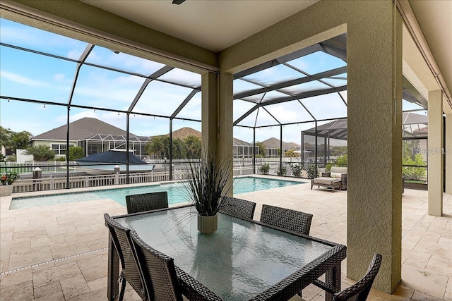 view of patio / terrace with a fenced in pool and glass enclosure