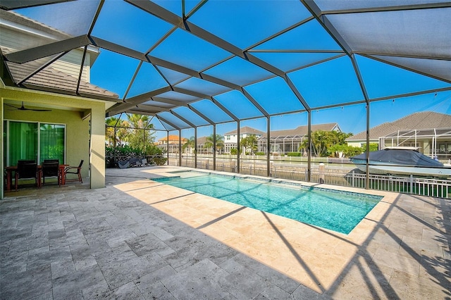 view of pool featuring a patio area, ceiling fan, and a lanai