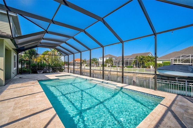 view of pool featuring glass enclosure and a patio