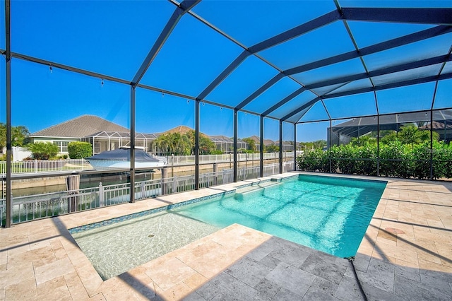 view of pool featuring a water view, a patio area, and glass enclosure