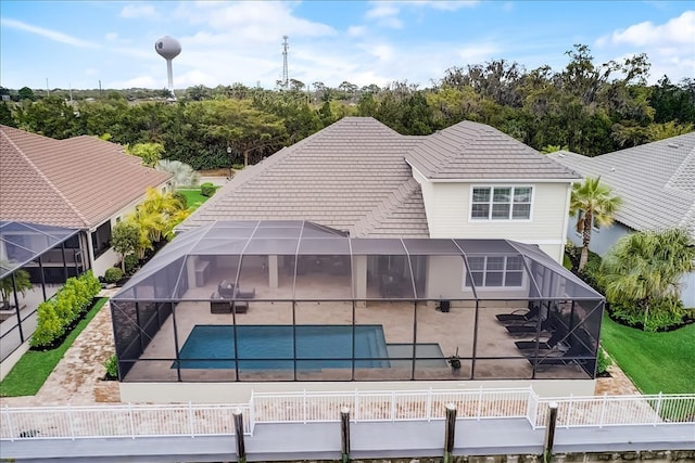 view of front facade with a patio area, a fenced in pool, and a lanai