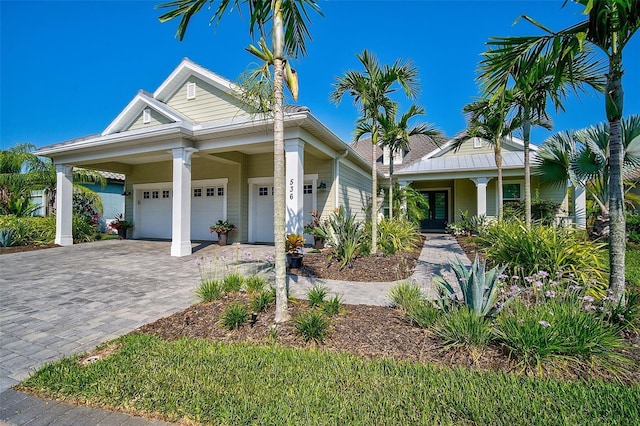 view of front of home with covered porch and a garage