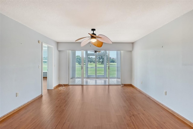 unfurnished room featuring ceiling fan and light hardwood / wood-style flooring