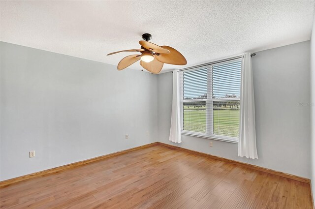 unfurnished room featuring ceiling fan, a textured ceiling, and hardwood / wood-style flooring