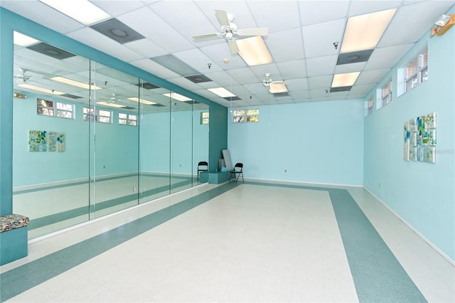 unfurnished room featuring a drop ceiling and ceiling fan