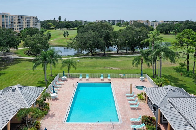 view of pool with a water view and a patio