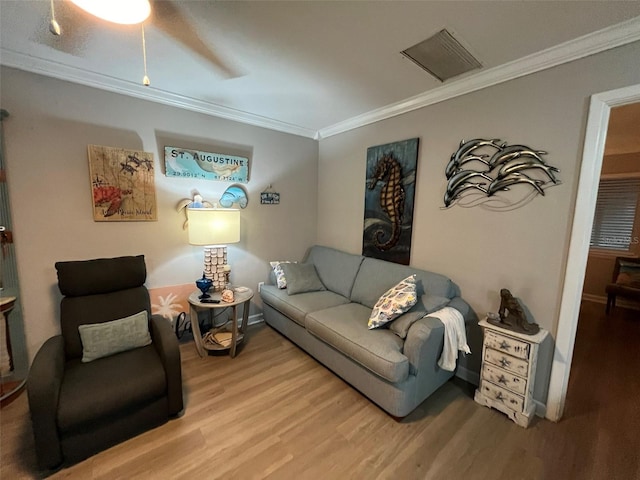 living room featuring crown molding, hardwood / wood-style floors, and ceiling fan