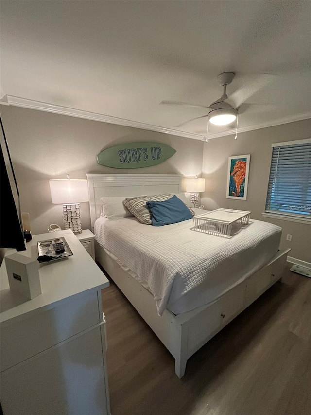 bedroom with dark wood-type flooring, ceiling fan, and ornamental molding