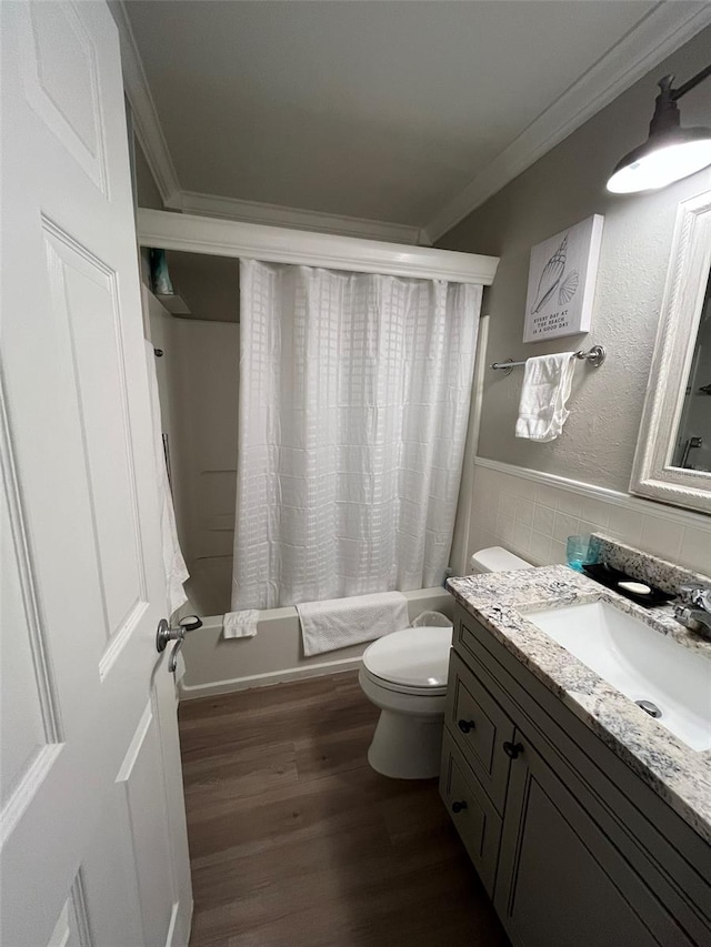 full bathroom featuring toilet, hardwood / wood-style floors, crown molding, vanity, and shower / bath combo