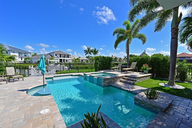 view of pool featuring an in ground hot tub, a water view, and a patio