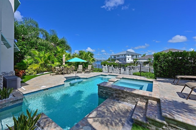 view of swimming pool with an in ground hot tub and a patio