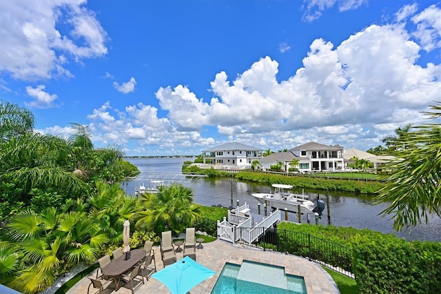 view of swimming pool with a water view, a dock, and a patio area