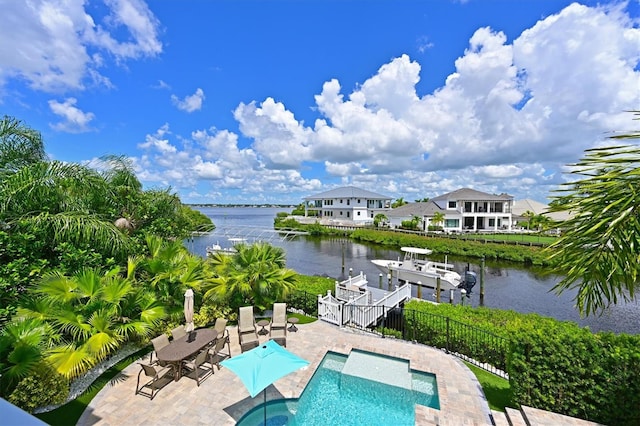 view of pool with a dock, a patio, and a water view