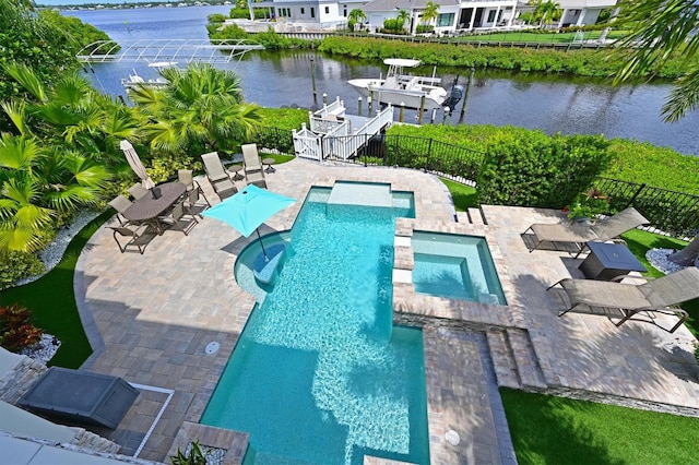 view of pool featuring a patio, a water view, a boat dock, and an in ground hot tub