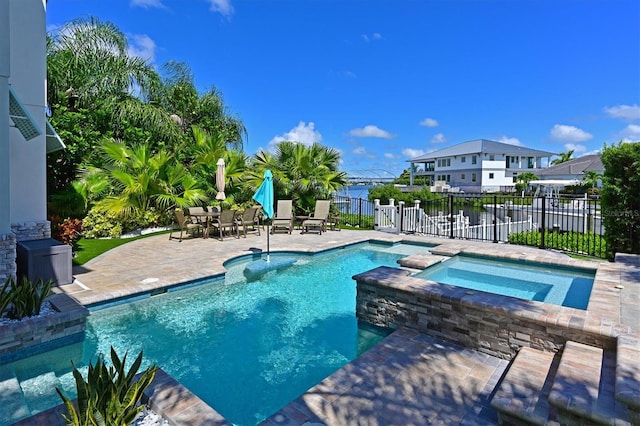 view of swimming pool with a patio and an in ground hot tub