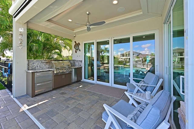 view of patio / terrace with an outdoor kitchen, grilling area, and ceiling fan