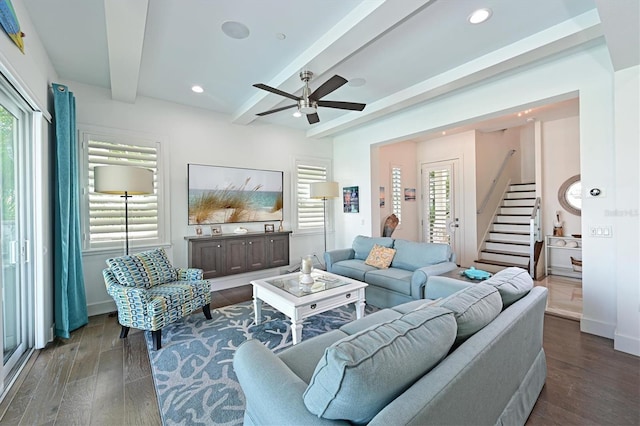 living room with dark hardwood / wood-style flooring, ceiling fan, and beam ceiling