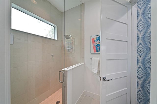 bathroom featuring a shower with door