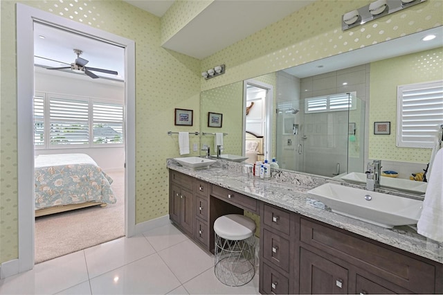 bathroom featuring walk in shower, ceiling fan, vanity, and tile patterned floors