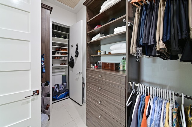 spacious closet with light tile patterned floors