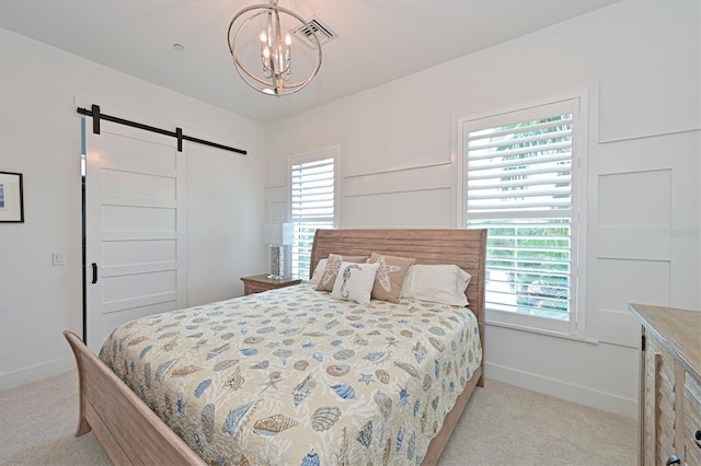 carpeted bedroom with a barn door and an inviting chandelier