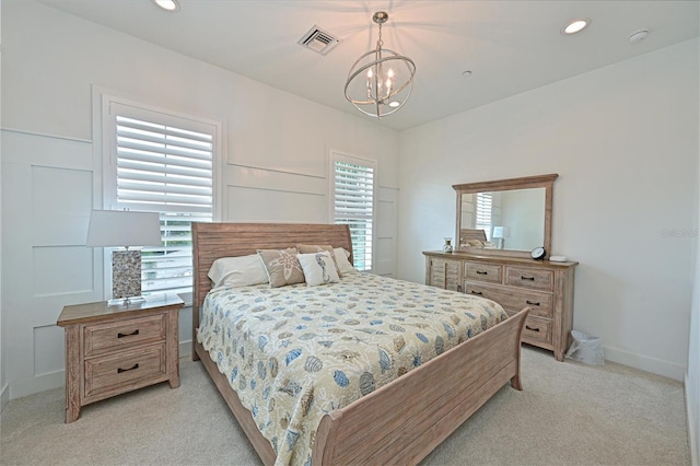 bedroom featuring multiple windows, light carpet, and a chandelier