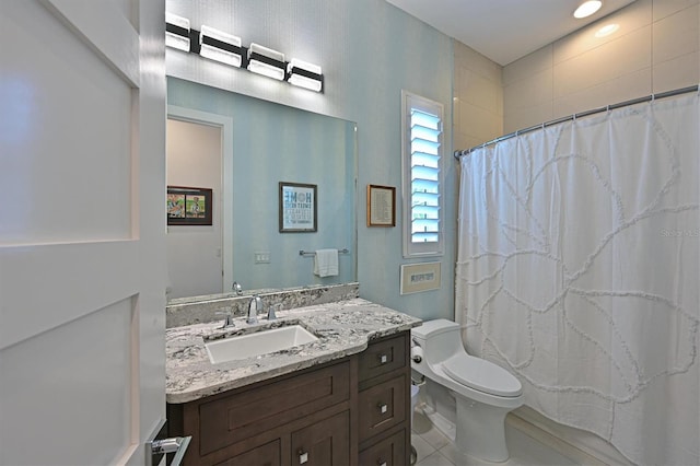 bathroom with vanity, curtained shower, and toilet