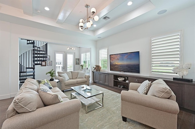 living room featuring hardwood / wood-style flooring, beamed ceiling, french doors, and a chandelier