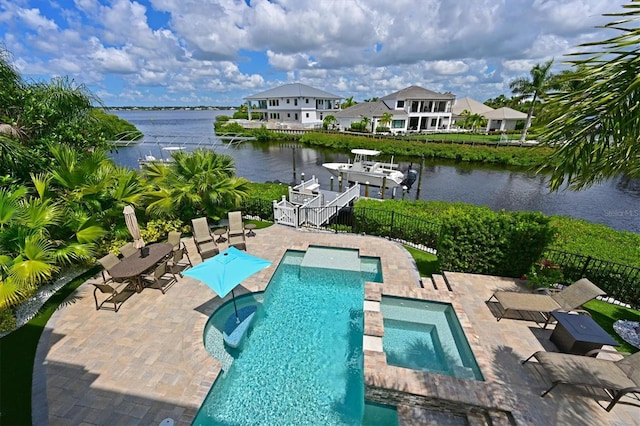 view of swimming pool with a water view, an in ground hot tub, a patio area, and a boat dock