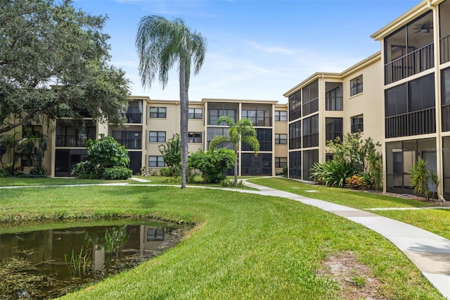 view of community with a yard and a water view