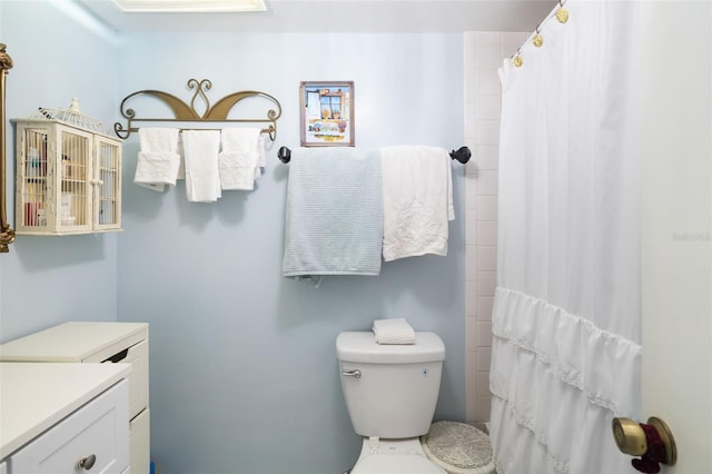 bathroom with vanity, toilet, and a shower with curtain