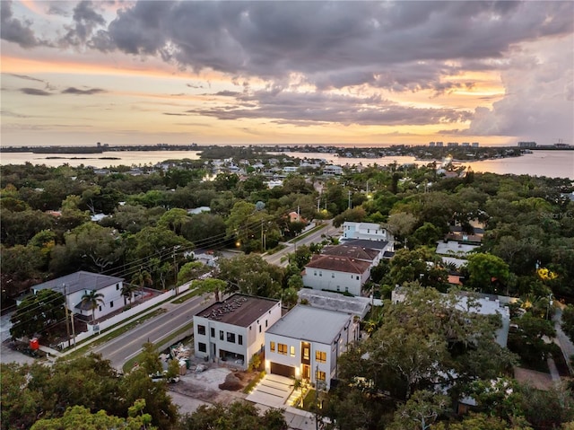 aerial view at dusk with a water view