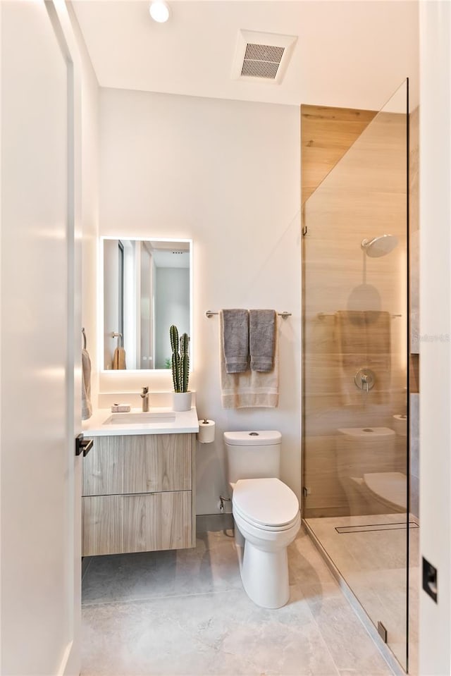 bathroom with vanity, a shower, and toilet